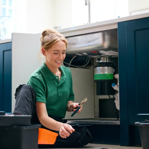 female-plumber-with-digital-tablet-fixing-waste-di-2024-10-19-12-02-46-utc