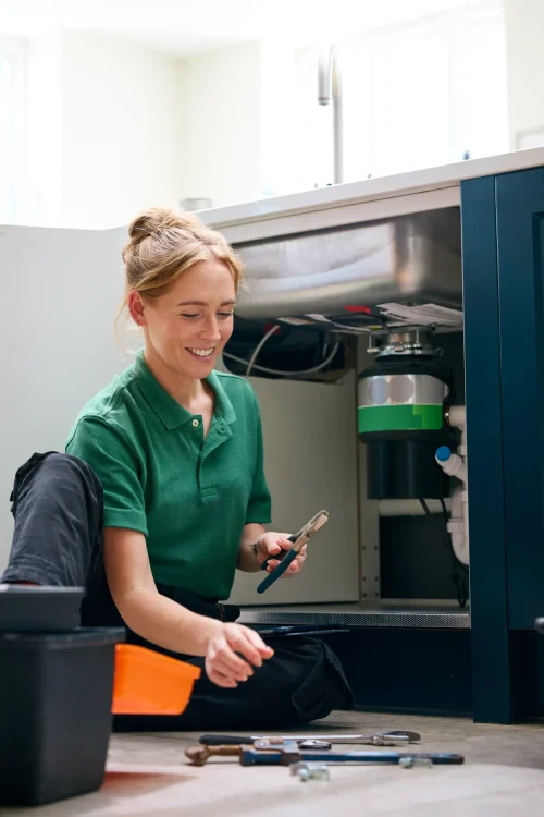 female-plumber-with-digital-tablet-fixing-waste-di-2024-10-19-12-02-46-utc